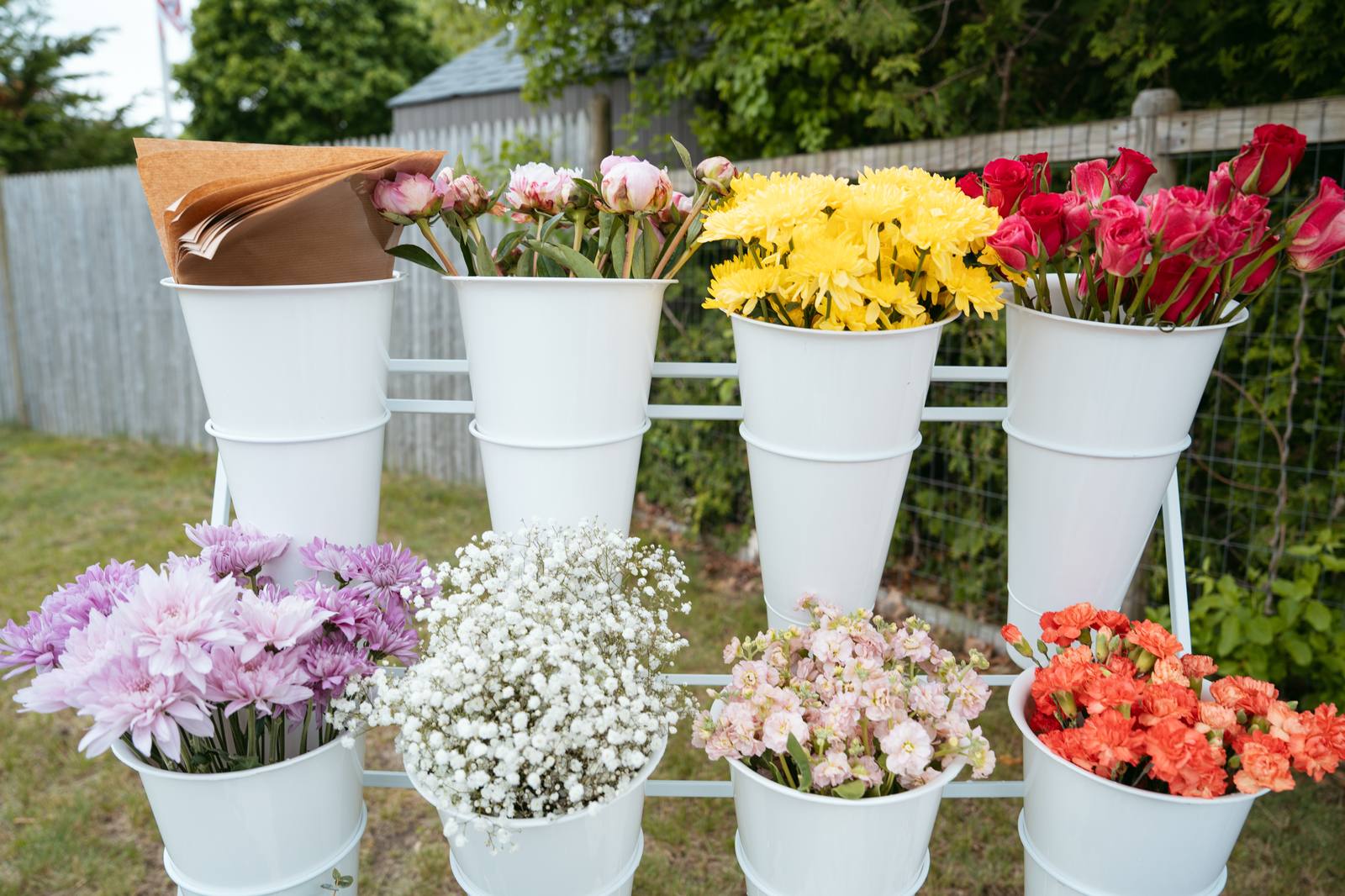 The Sunday Blooms bucket cart filled with peonies, yellow mums, roses, and baby's breath