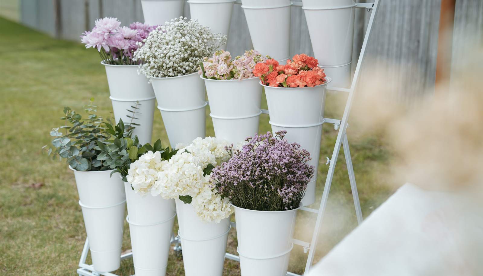 The Sunday Blooms flower bar stocked with chrysanthemums, baby's breath, stock, carnations, hydrangea, and eucalyptus